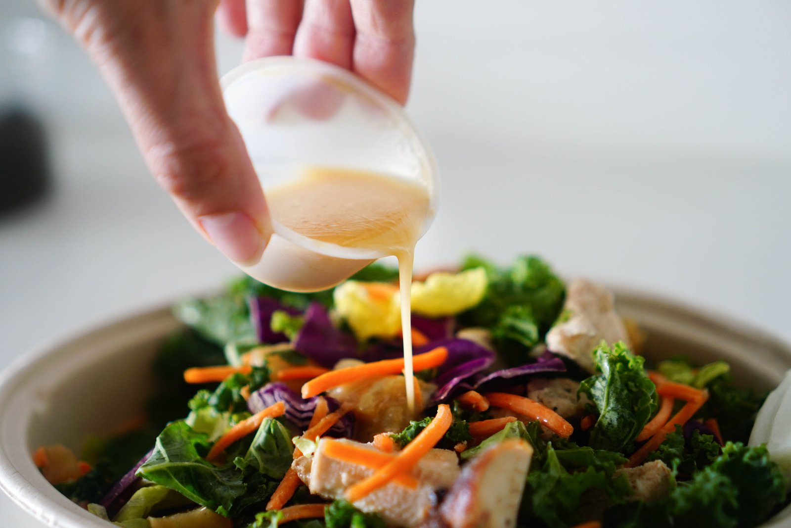 Fresh salad with colourful vegetables and dressing